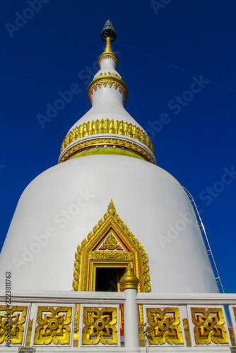 Obraz na plátně Traditional Buddhist temple stupa in Thailand, showcasing distinctive Southeast Asian religious architecture and intricate ornamental details