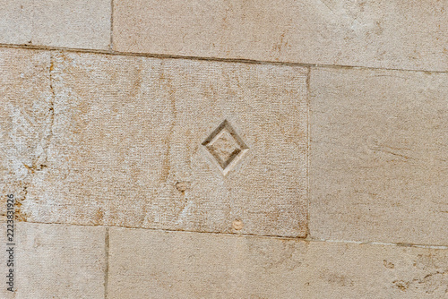 Carved diamond symbol on sandstone wall block on October 3, 2026 in Geneva, Switzerland