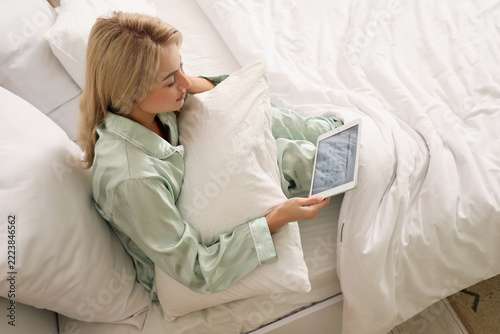 Time management and planning, woman in pajamas checking digital calendar on t...