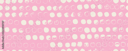 Brush drawn spots in a row seamless pattern. Hand drawn polka dot background with uneven round shapes with rough edges. Small organic dots girly wrapping paper on pink background.