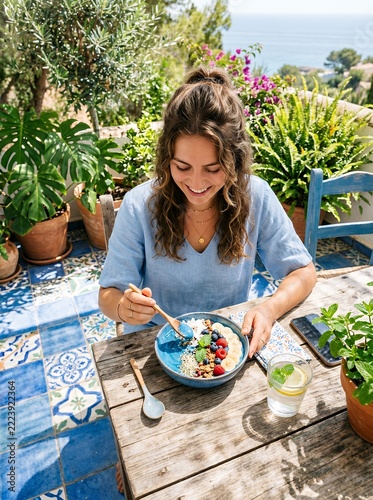 Young Woman Enjoying Healthy Breakfast Bowl Outdoors.