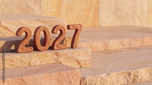 Year 2027 numbers on natural sandstone blocks. Brown clay digits arranged on layered stone steps. Future planning and upcoming milestone concept photo for corporate strategy and business roadmaps
