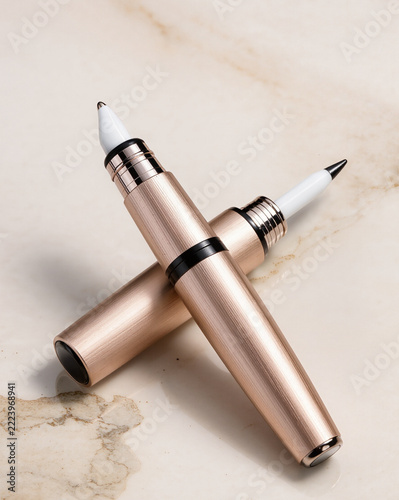 Rose Gold Cosmetic Applicators with Metallic Finish on Beige Background