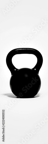 Silhouette of a black kettlebell on a white background with subtle shading highlighting its curves, kettlebells, silhouette
