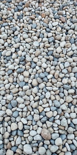 Small, rounded pebbles in a mix of beige, white, gray, and blue hues, pattern, mineral