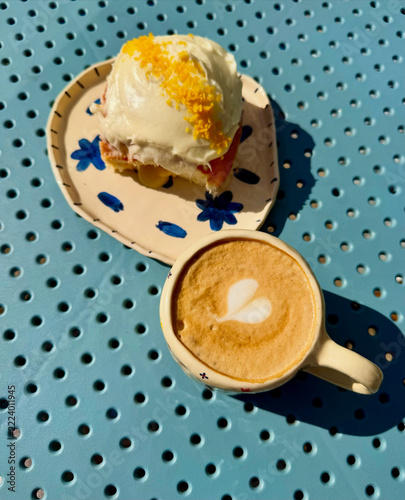 Cinnamon roll with cream cheese frosting and cappuccino