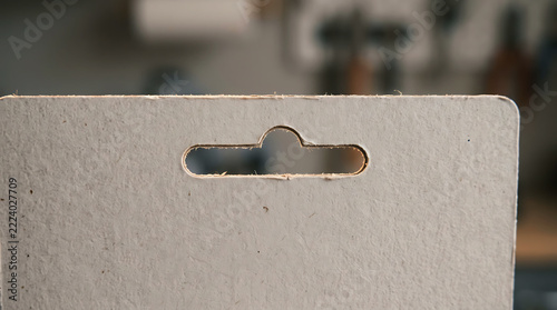 Close-up of cardboard packaging with euro hole hanger
