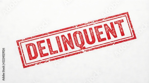 Red ink stamp reading delinquent on a white background with rubber financial distressed textured