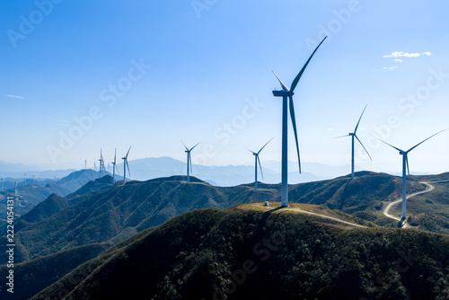 Obraz na plátně Wind turbines generating electricity under blue sky