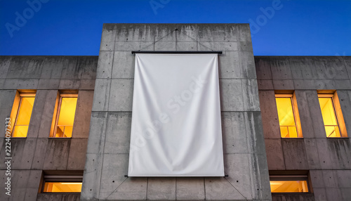 Large white mockup banner hanging on modern concrete building