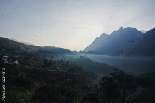 Beautiful view of Doi Luang Chiang Dao mountains in Chiang Mai, Thailand with mist scenery camping tents and cool climate offering peaceful nature escape for travelers.