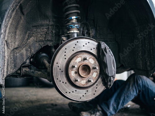 Close-Up View of a Car Disc Brake Rotor and Caliper Assembly Inside a Wheel Well