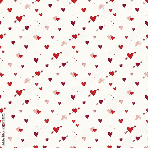 Cute seamless pattern with scattered red and pink hearts and cupid arrows for Valentine's Day background