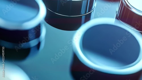 Cinematic AI generated macro video of sleek metallic cylinders with reflective surfaces. Smooth gliding camera over futuristic hardware grid featuring vibrant blue light reflections and soft bokeh