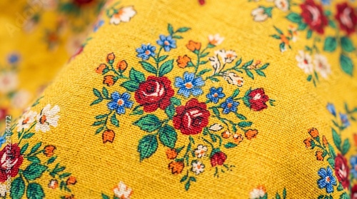 Vibrant Floral Embroidered Fabric with Yellow Background and Red Roses