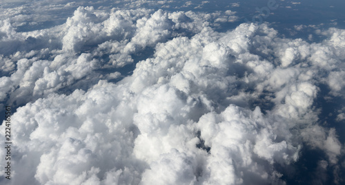 Aerial view mountain covered with snow over clouds. Aerial view mountain valley. Beautiful view from above surface of mountain hills covered with clouds