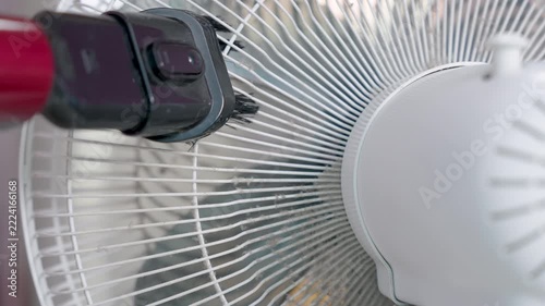 Close-up, A vacuum cleaner being used to remove dirt and dust from a floor fan, negatively affect the respiratory system.