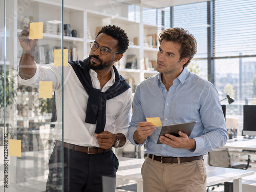 Male Colleagues Planning Project With Sticky Notes in Modern Office