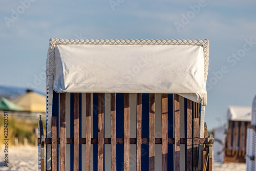 Strandkorb beach chair on sand by the sea