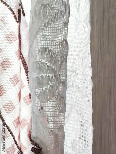 A tactile curtain with hadows across a softly textured surface. Minimalist backgrounds, interior design, and organic aesthetics.