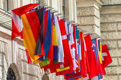 Row of national flags hanging on building facade