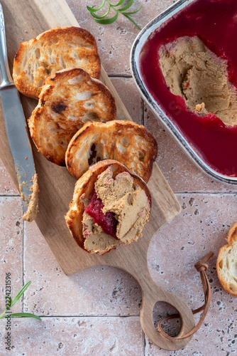 Delicious Spread of Liver Pate Served With Toasted Bread and Jelly on a Wooden Board