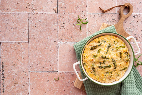 Ground Chicken and Asparagus Casserole With Cheese on a Wooden Board