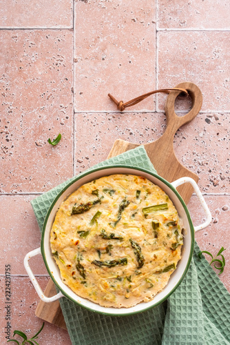 Ground Chicken and Asparagus Casserole With Cheese on a Wooden Board