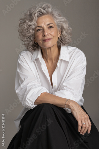 Confident Mature Woman With Natural Gray Hair in Studio