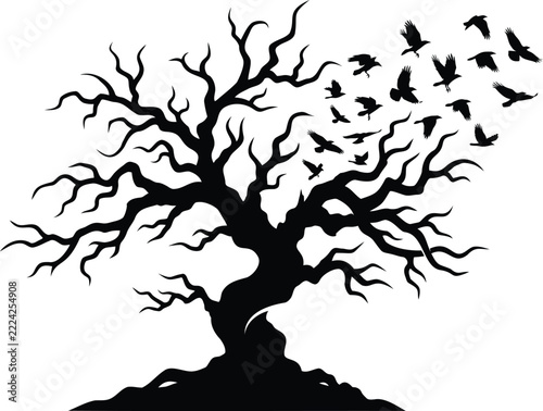 Silhouette of a gnarled, leafless oak tree with a flock of crows taking flight dead tree