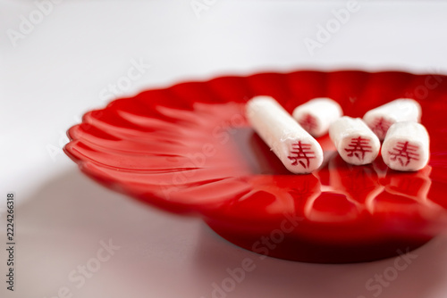 Traditional Japanese Chitose Ame candy for Shichi Go San on a red plate