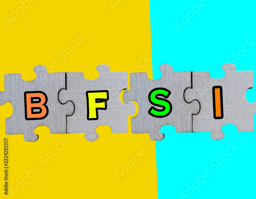 BFSI Acronym on Jigsaw Puzzle Pieces Representing Banking Financial Services and Insurance Industry Concept on Split Yellow and Cyan Blue Background 