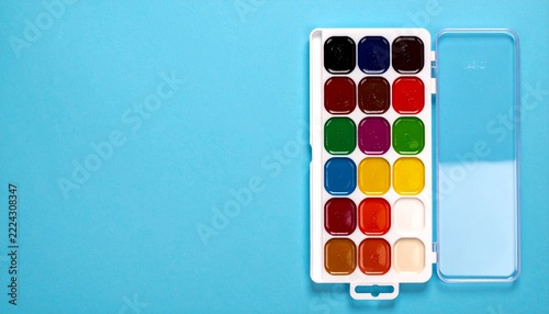 Compact watercolor paint palette with integrated wells of vivid pigments, clean molded case and artist-friendly layout, colorful creative painting equipment. Photorealistic studio photography13