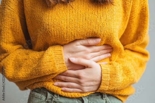young woman hands in belly, stomach pain from food poisoning