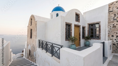 Traditional white greek building with blue dome in santorini