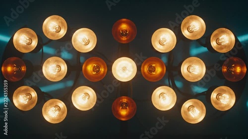 Vintage light bulb installation glowing in darkness creating artistic geometric interior decoration pattern