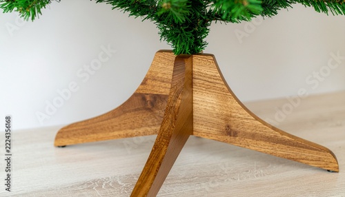 Close up on the bottom of a miniature Christmas tree with wooden legs