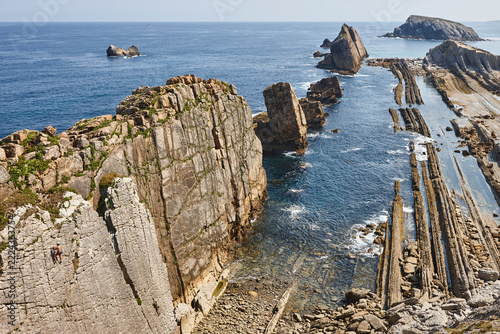 Solitary rocky beach of Arnia. Climbers. Cantabria coastline. Spain