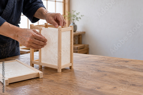 Japanese artisan assembling traditional washi andon lantern