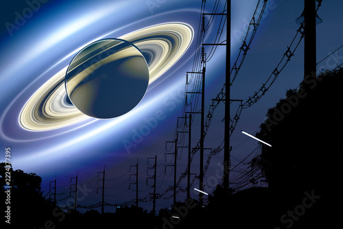 Saturn shadow under ring back silhouette power electric poles with top tree and teal orange sunset sky