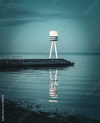 Coastal Beacon Reflecting Across Water