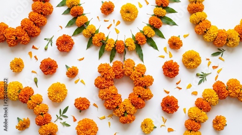 Vibrant Marigold Flower Garlands and Petals Arranged in Decorative Patterns on White Background