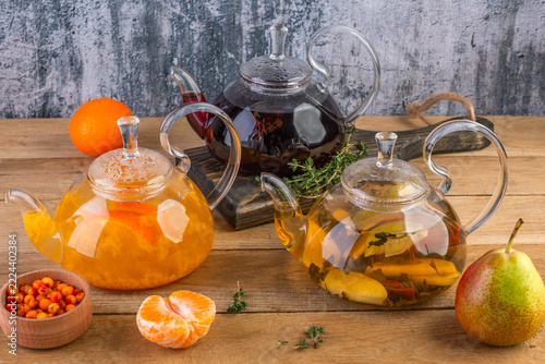 Spiced tea in glass teapots, a warming sea buckthorn drink, pear tea, thyme tea