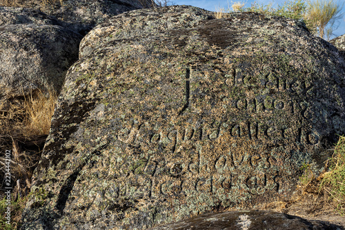Historic funerary inscription carved in rock in Malpartida de Cáceres, Spain.
