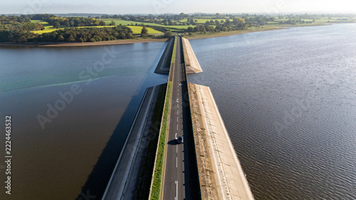 Car moving over Blithfield Reservoir, Staffordshire, England.