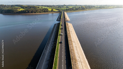 Traffic moving over Blithfield Reservoir, Staffordshire, England.