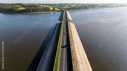 Cars moving over Blithfield Reservoir, Staffordshire, England.