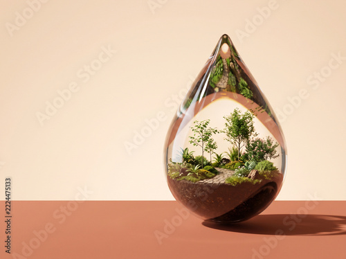 Garden growing inside a transparent water drop on beige background