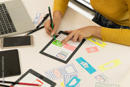 Creative web designer planning UI application and developing digital template