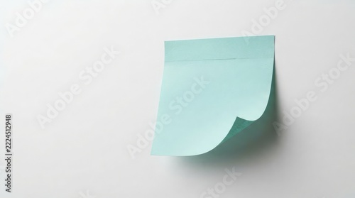 Single turquoise sticky note attached to a white surface with a partially peeled corner